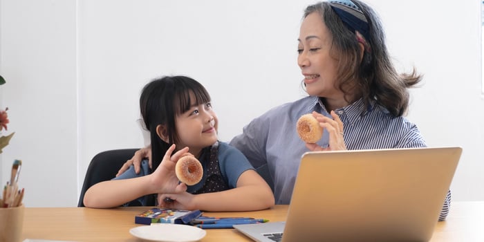 little girl eating snacks with grandma photo