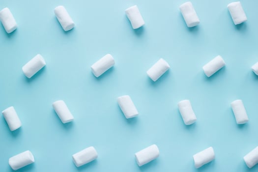 Geometric pattern of white marshmallows on blue pastel background. Food concept in minimal flatlay style photo