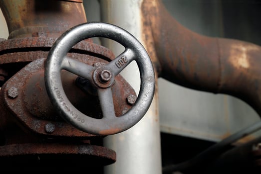 Rusty valve in abandoned steel factory photo