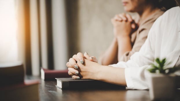 Two women praying worship believe photo