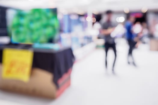 Television shelf in eletronic department store blurred background photo