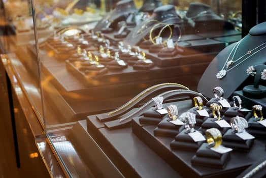 Gold jewelry diamond shop with rings and necklaces luxury retail store window display photo