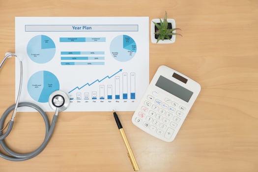 Stethoscope with financial statement calculator and pen photo