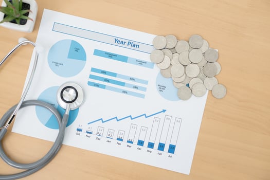 Stack of money coins with stethoscope checking photo