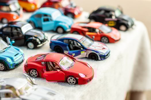 Close-up image of a red luxury sedan toy model. photo