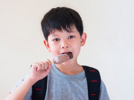 Boy eating ice cream. Photo is focused at his eyes.