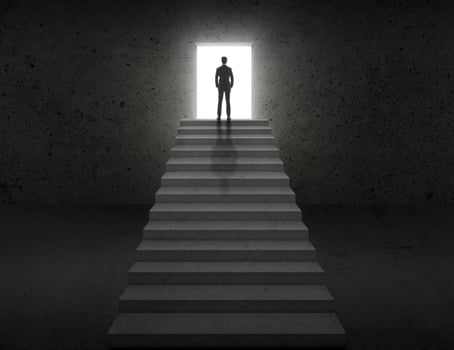 Vision concept. Successful businessman standing on staircase photo