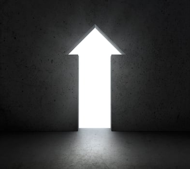 front of bright big arrow shining door in a concrete wall photo