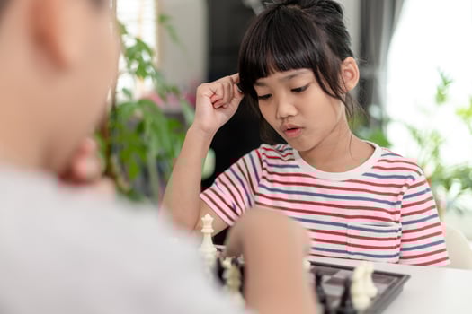 Little boy and little girl are playing chess at home.Children playing chess photo