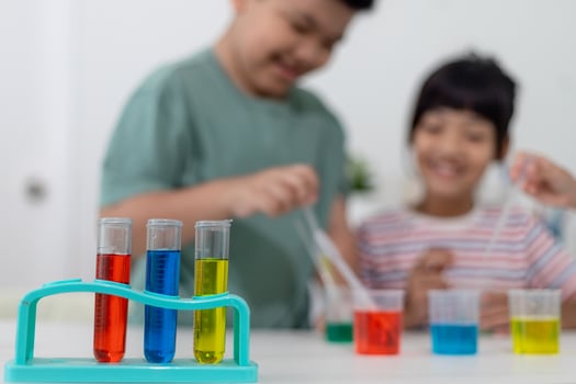 Asian Children enthusiastically watch chemistry experiments. photo