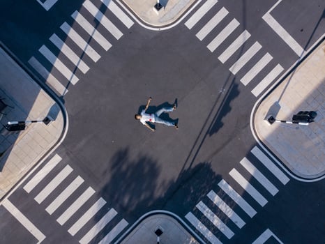 Seriously injured pedestrian man laying down on the middle of crossroad intersection street after car crash with blood for safety traffic road and transportation photo