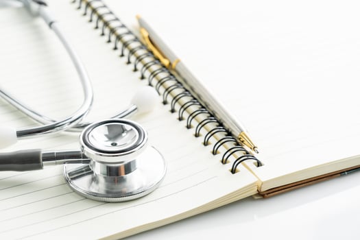 Stethoscope on blank notepad photo