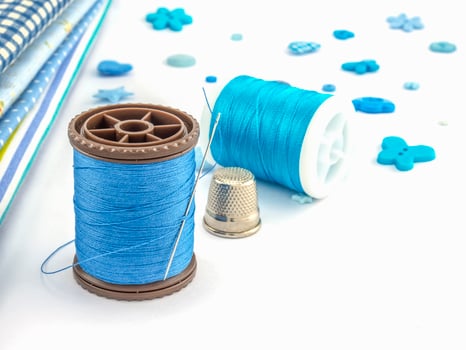 Blue embroidery set over white background photo