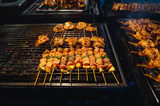 Barbecue skewers on a street side grill photo