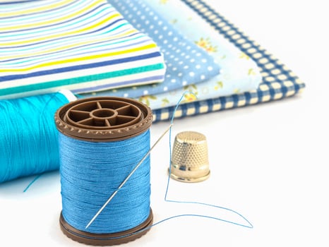 Blue embroidery set over white background photo