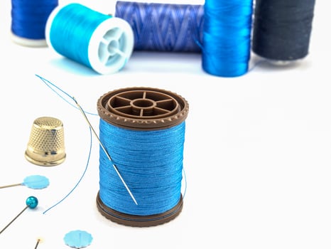 Blue embroidery set over white background photo