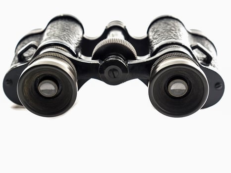 Old antique binoculars isolated over white background photo