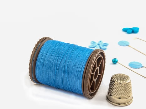Blue embroidery set over white background photo