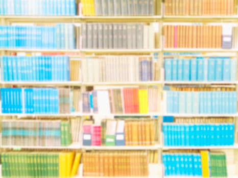 Blurred bookshelf library for background use photo