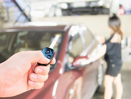 Man is giving a car key to somebody photo