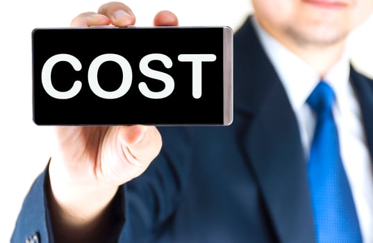COST, word on mobile phone screen in blurred young businessman hand over white background, business concept photo