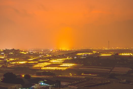 Amazing sunset landscape in agricultural greenhouse valley in Da Lat City. The light from the greenhouse to grow flowers in Da Lat. Travel and landscape concept photo