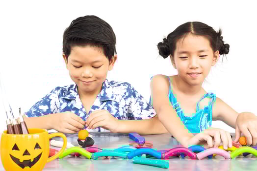 Boy and girl are happily playing clay toy photo