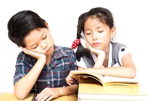 Sister try to teach her naughty younger brother to read a book isolated over white background photo