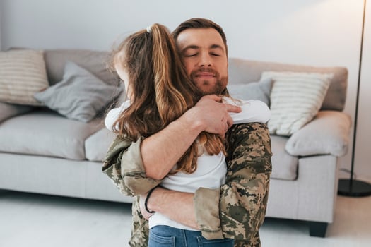 Finally at home. Soldier in uniform is with his little daughter photo