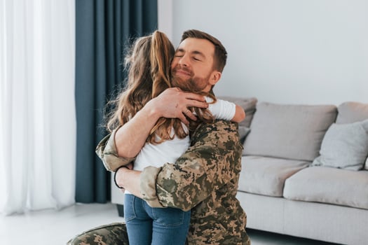 Finally at home. Soldier in uniform is with his little daughter photo