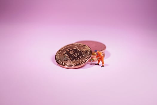Technician worker figure standing in front of bitcoin. Bitcoin mining concept. photo