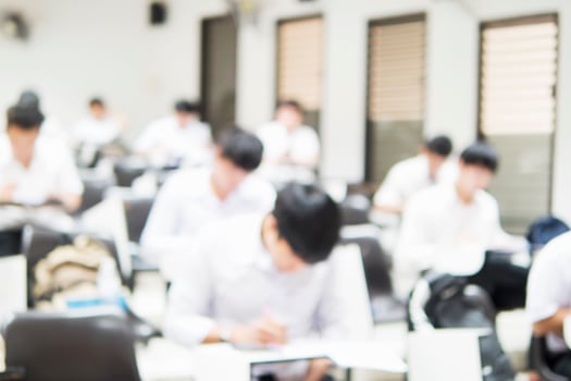 Blurred picture of student in the examination room photo