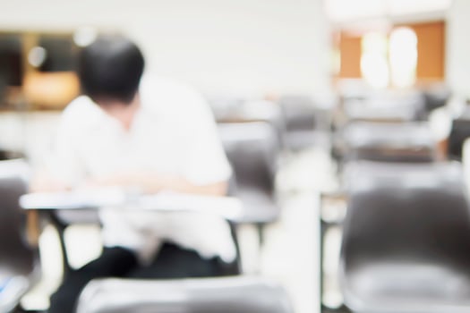 Blurred picture of student in the examination room photo