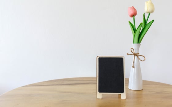 Blank black frame mock up picture frame  mini  tree in pot on wooden table photo