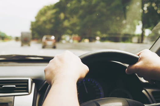 Close up of a man driving car using two hands photo