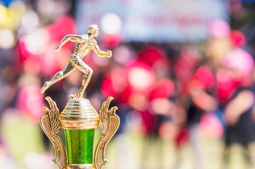 Sport trophy over blur crowded people in school sport day festival photo