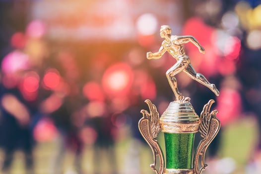 Sport trophy over blur crowded people in school sport day festival photo