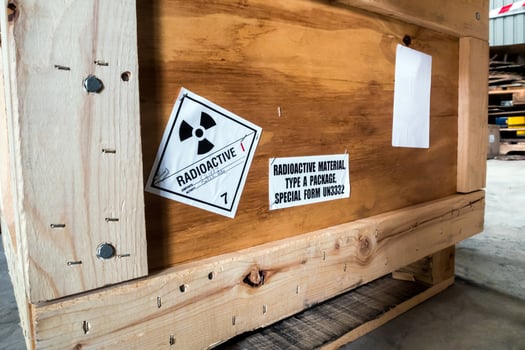 Radiation label beside the transport wooden box Type A package photo