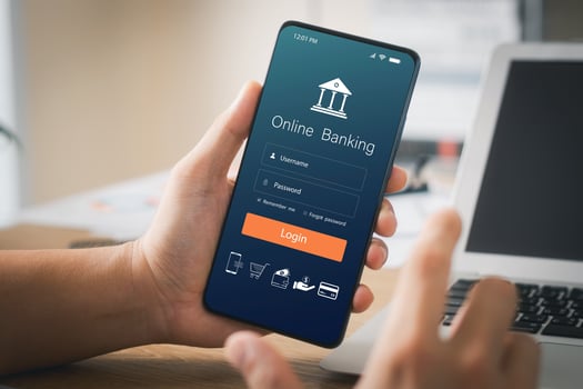 Male executive using smartphone to conduct online mobile banking, investing in stocks and mutual funds, retirement investment ideas. photo
