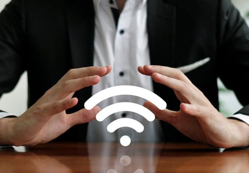 Businessman protects wireless network with hands photo