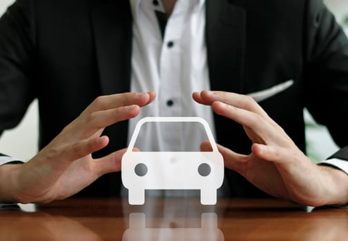 Businessman holding sign with a car symbol photo