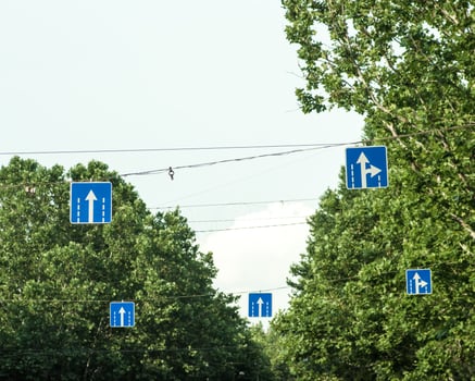 Blue road signs hanging above the highway. photo