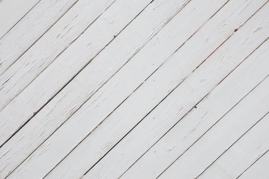 White painted cracked wood planks placed diagonally. Abstract background. photo