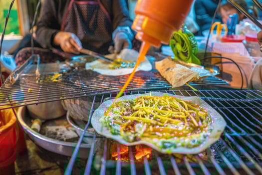 Close up Grilled girdle cake Banh Trang Nuong , a famous Vietnamese street stall eatery, a popular Vietnamese food in Da lat at night photo