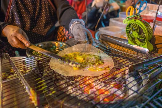 Close up Grilled girdle cake Banh Trang Nuong , a famous Vietnamese street stall eatery, a popular Vietnamese food in Da lat at night photo