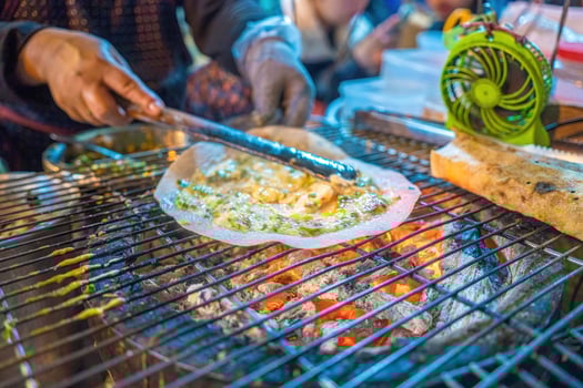 Close up Grilled girdle cake Banh Trang Nuong , a famous Vietnamese street stall eatery, a popular Vietnamese food in Da lat at night photo