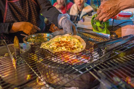 Close up Grilled girdle cake Banh Trang Nuong , a famous Vietnamese street stall eatery, a popular Vietnamese food in Da lat at night photo