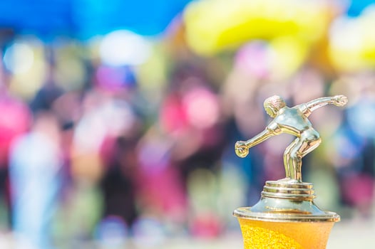 Sport trophy over blur crowded people in school sport day festival photo