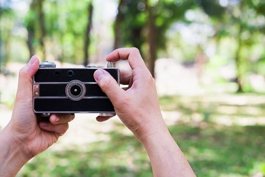Man taking photo using old retro camera