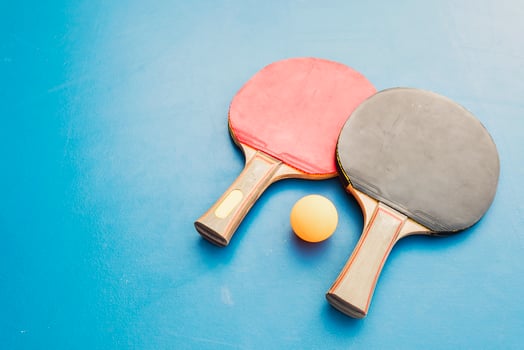 Table tennis equipment on blue table photo